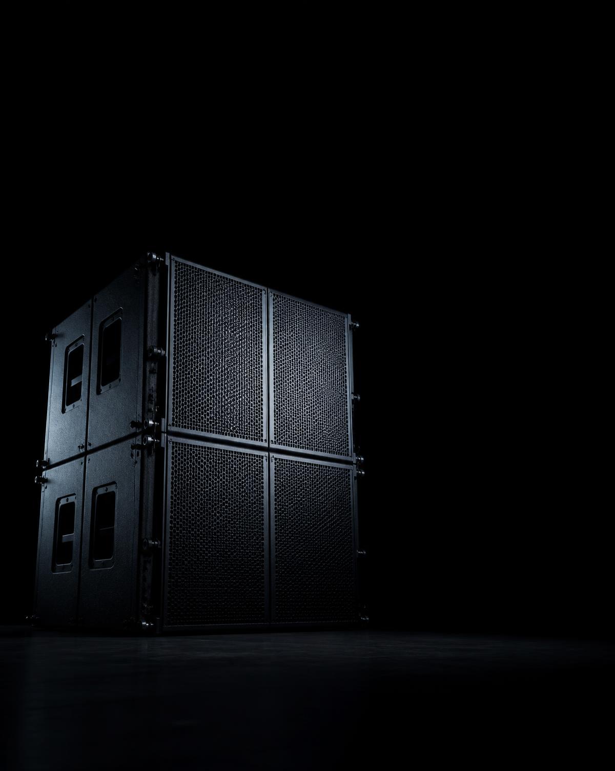 Sonara subwoofer cabinets on a darkened stage